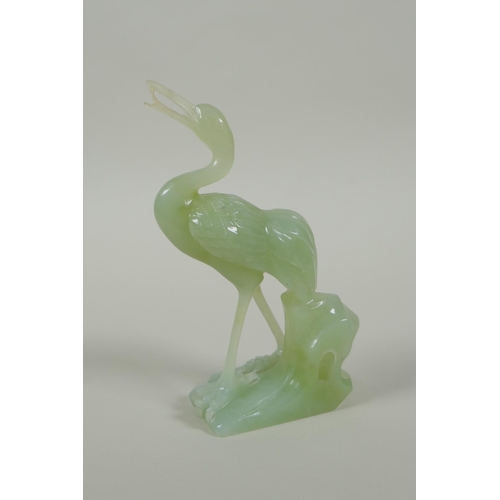 195 - A Chinese green jade carving of a crane, 16cm high