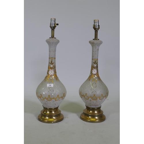 196 - A pair of cut and etched glass table lamps with gilt and enamel decoration, a brass bases, 67cm high