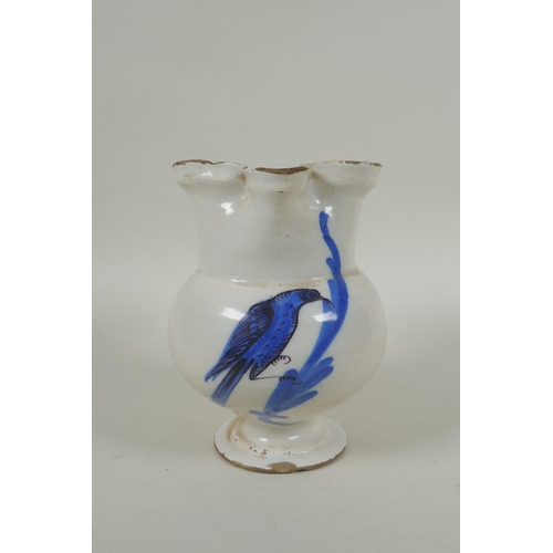 198 - An C18th Italian faience jug decorated with a bird, AF, 16cm high