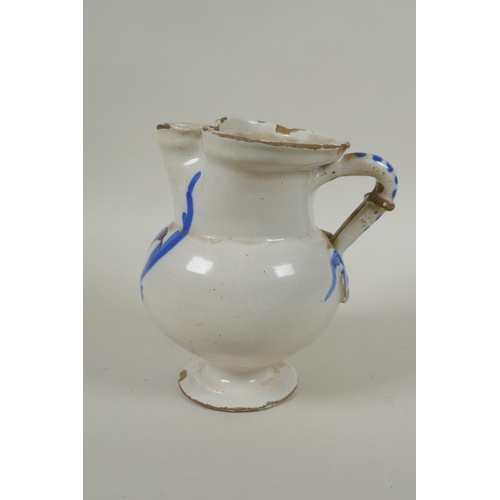 198 - An C18th Italian faience jug decorated with a bird, AF, 16cm high