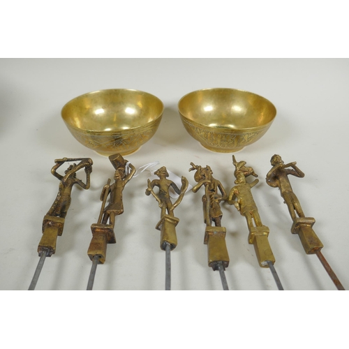 199 - A set of six Indian gilt bronze figural skewers, 50cm long, and a pair of Islamic brass bowls