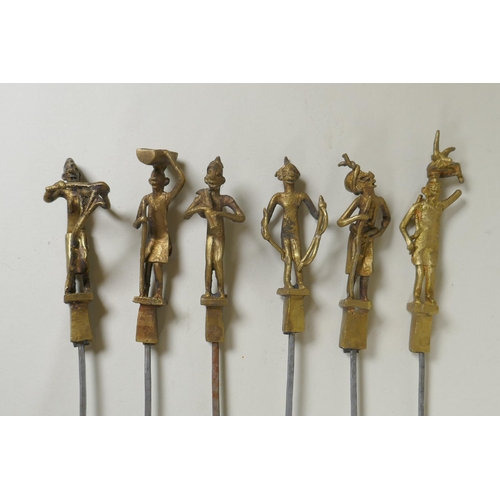 199 - A set of six Indian gilt bronze figural skewers, 50cm long, and a pair of Islamic brass bowls