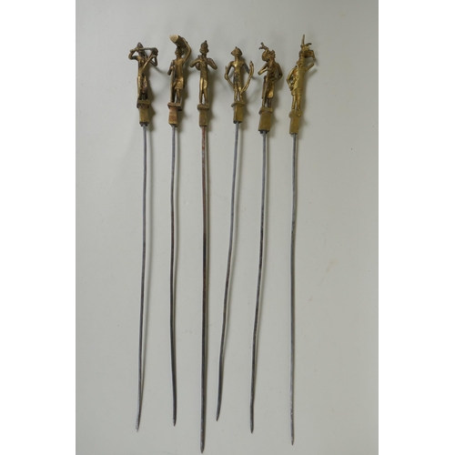 199 - A set of six Indian gilt bronze figural skewers, 50cm long, and a pair of Islamic brass bowls