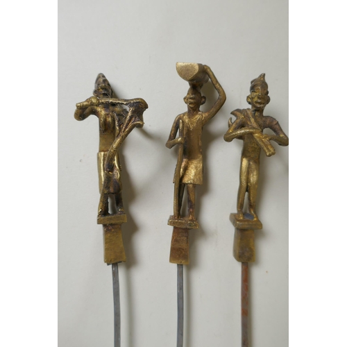 199 - A set of six Indian gilt bronze figural skewers, 50cm long, and a pair of Islamic brass bowls