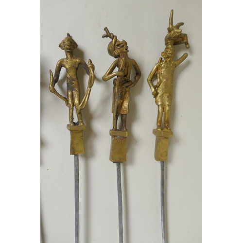 199 - A set of six Indian gilt bronze figural skewers, 50cm long, and a pair of Islamic brass bowls