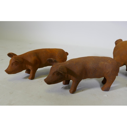 207 - A cast iron garden figure of a sow and two smaller piglets, largest 42cm