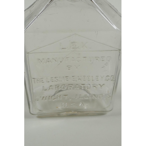 21 - An antique American apothecary bottle, by Leslie E. Keeley (L.E.K.), 15cm high