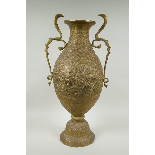 210 - An Indian bronze urn with two handles in the form of cobras, with allover repousse decoration depict... 