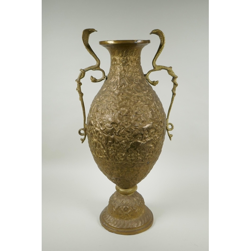 210 - An Indian bronze urn with two handles in the form of cobras, with allover repousse decoration depict... 