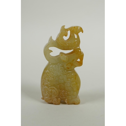 211 - A Chinese carved and pierced jade pendant decoration with kylin and phoenix, 8cm high