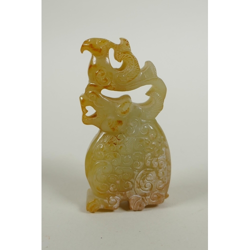 211 - A Chinese carved and pierced jade pendant decoration with kylin and phoenix, 8cm high