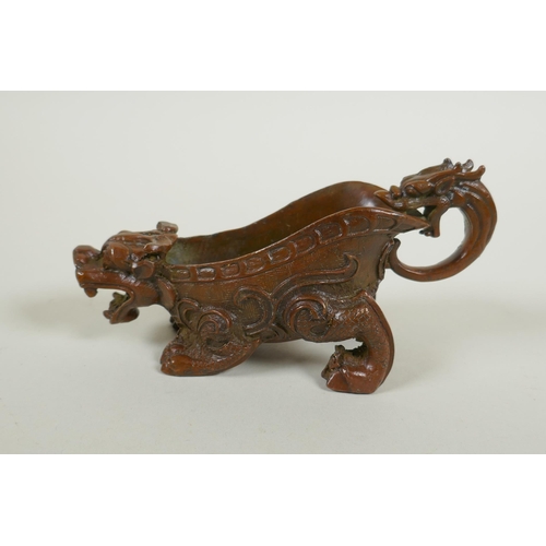 213 - A Chinese bronze libation cup in the form of a kylin, 15cm long