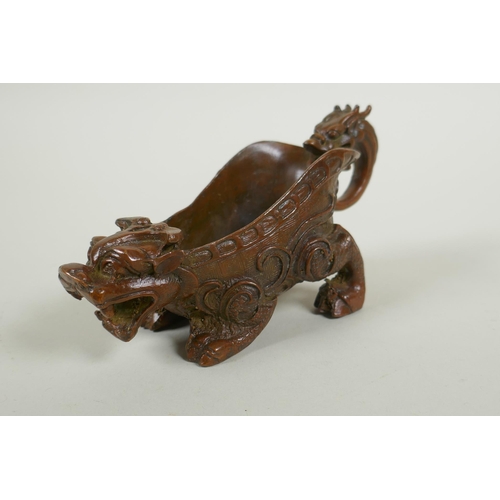 213 - A Chinese bronze libation cup in the form of a kylin, 15cm long