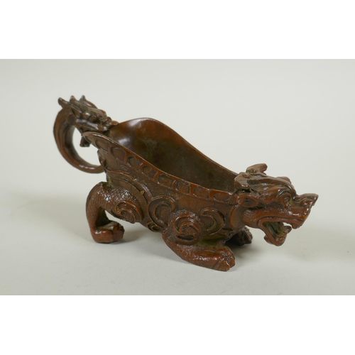 213 - A Chinese bronze libation cup in the form of a kylin, 15cm long