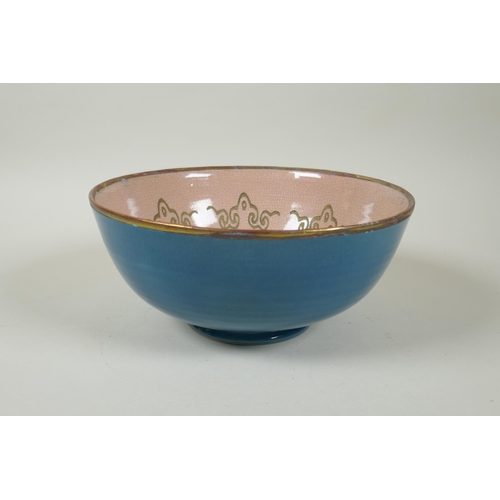 215 - An Oriental teal crackle glazed porcelain bowl with gilt metal rim, the bowl with chased Buddhist ma... 