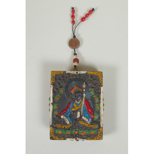 225 - A Tibetan carved and painted hardstone tablet depicting a deity, the reverse set with abalone, dzi b... 