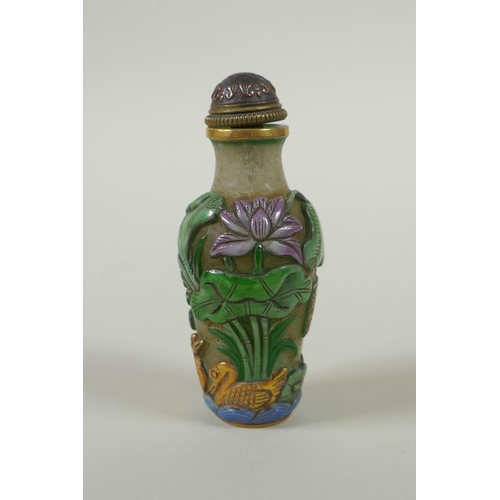 226 - A Peking glass snuff bottle with carved and enamelled decoration of frogs, waterfowl and lotus flowe... 