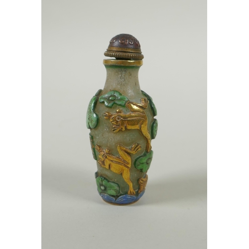 226 - A Peking glass snuff bottle with carved and enamelled decoration of frogs, waterfowl and lotus flowe... 