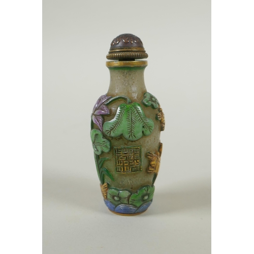 226 - A Peking glass snuff bottle with carved and enamelled decoration of frogs, waterfowl and lotus flowe... 