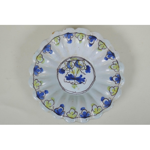 228 - A C17th/C18th English Delft fluted dish, with floral decorated to centre, AF, 22cm diameter