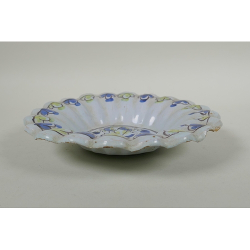 228 - A C17th/C18th English Delft fluted dish, with floral decorated to centre, AF, 22cm diameter