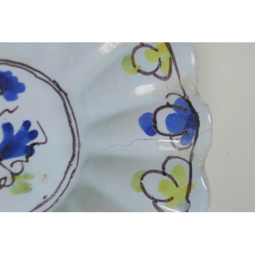 228 - A C17th/C18th English Delft fluted dish, with floral decorated to centre, AF, 22cm diameter