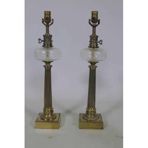 237 - A pair of brass and cut glass table lamps, raised on fluted columns, 60cm high