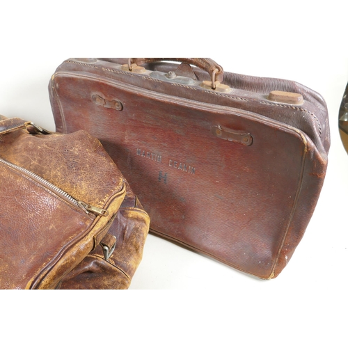 244 - A vintage leather holdall, together with a smaller suitase