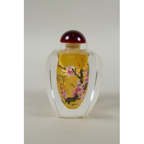 248 - A Chinese reverse painted glass snuff bottle decorated with a branch in bloom, 9cm high