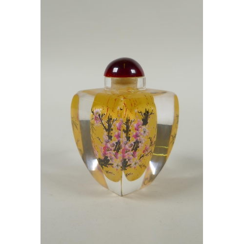 248 - A Chinese reverse painted glass snuff bottle decorated with a branch in bloom, 9cm high