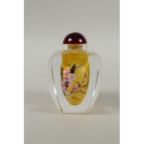 248 - A Chinese reverse painted glass snuff bottle decorated with a branch in bloom, 9cm high