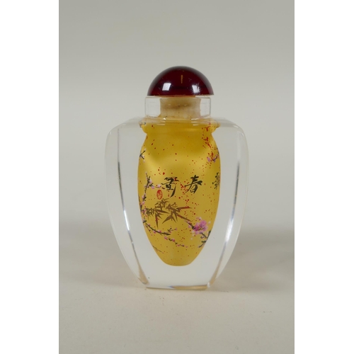 248 - A Chinese reverse painted glass snuff bottle decorated with a branch in bloom, 9cm high