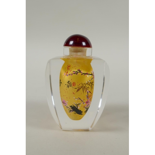 248 - A Chinese reverse painted glass snuff bottle decorated with a branch in bloom, 9cm high