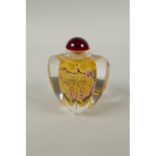 248 - A Chinese reverse painted glass snuff bottle decorated with a branch in bloom, 9cm high