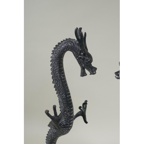 250 - A pair of bronzed metal dragons, 40cm high