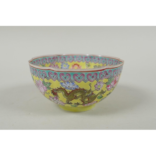 253 - A Chinese famille jaune eggshell porcelain rice bowl decorated with polychrome dragons, TongZhi seal... 