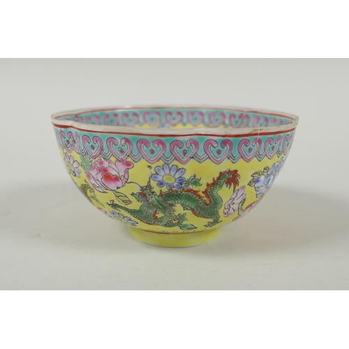 253 - A Chinese famille jaune eggshell porcelain rice bowl decorated with polychrome dragons, TongZhi seal... 