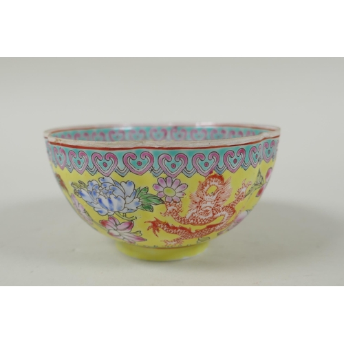 253 - A Chinese famille jaune eggshell porcelain rice bowl decorated with polychrome dragons, TongZhi seal... 