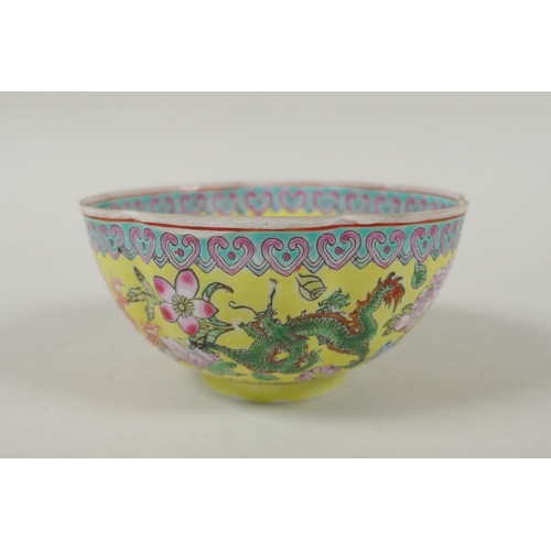 253 - A Chinese famille jaune eggshell porcelain rice bowl decorated with polychrome dragons, TongZhi seal... 