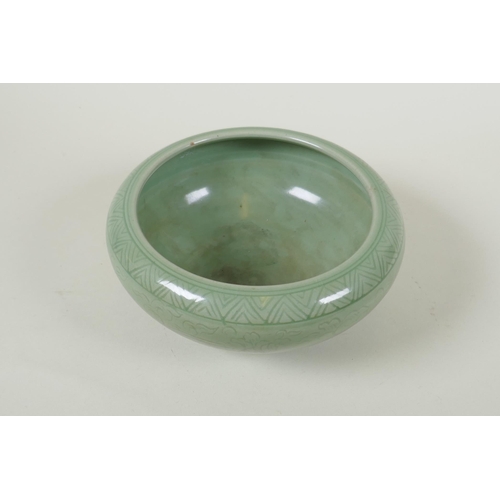 255 - A Chinese olive green glazed porcelain dish with incised scrolling floral decoration, 19cm diameter