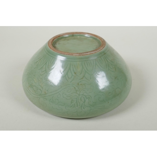 255 - A Chinese olive green glazed porcelain dish with incised scrolling floral decoration, 19cm diameter