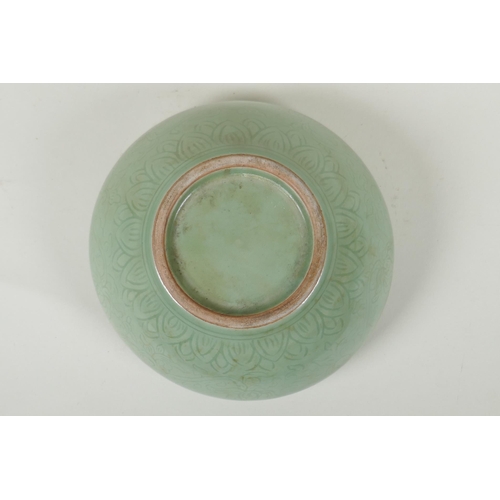 255 - A Chinese olive green glazed porcelain dish with incised scrolling floral decoration, 19cm diameter