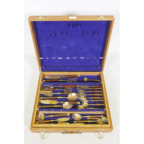 257 - A canteen of brass and rosewood cutlery, probably Thai or Malaysian, 12 place settings