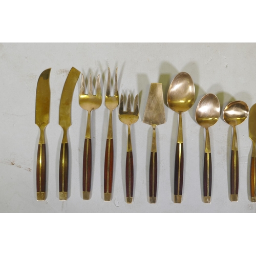 257 - A canteen of brass and rosewood cutlery, probably Thai or Malaysian, 12 place settings