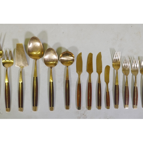 257 - A canteen of brass and rosewood cutlery, probably Thai or Malaysian, 12 place settings