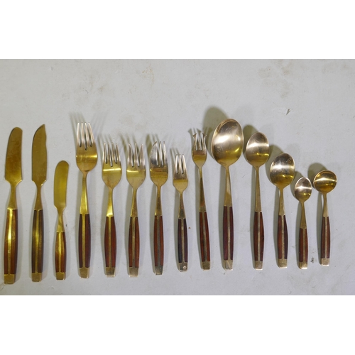 257 - A canteen of brass and rosewood cutlery, probably Thai or Malaysian, 12 place settings