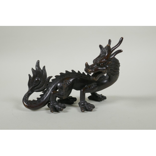 260 - An oriental bronze figure of a dragon, 15cm long