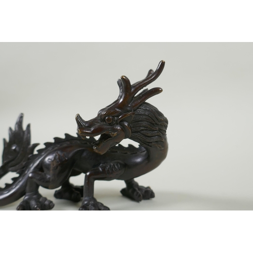 260 - An oriental bronze figure of a dragon, 15cm long