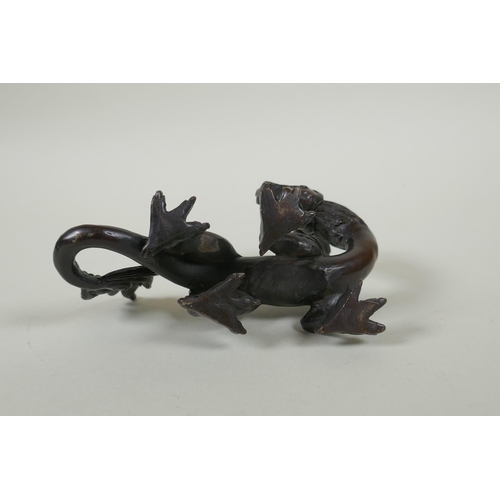 260 - An oriental bronze figure of a dragon, 15cm long