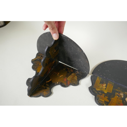 277 - A pair of Japanese export Japanned papier mache folding brackets, decorated with geisha and their pa... 